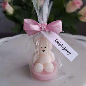 Ręcznie robiona świeczka sojowa w kształcie białego misia, zapakowana w przezroczysty woreczek z zawiązaną różową kokardką. Do woreczka przymocowana jest biała karteczka z napisem "Dziękujemy" - AtmosHome.pl